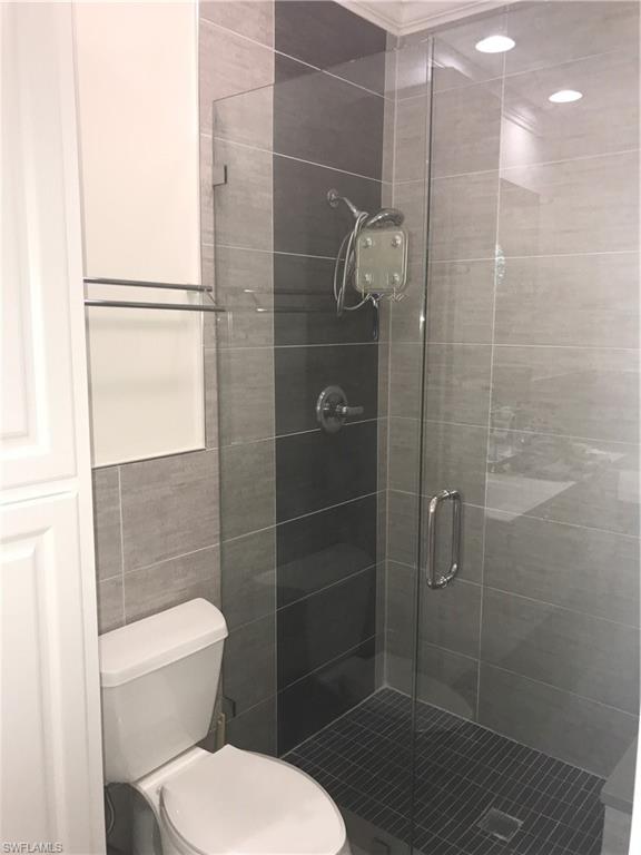3518 Zanzibar Way Naples, FL 34119 - Photo 10 of 13 a bathroom with a toilet and a shower