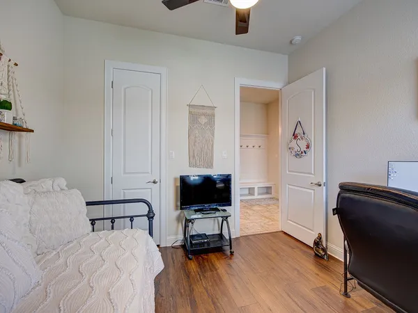 a bedroom with furniture and a flat screen tv