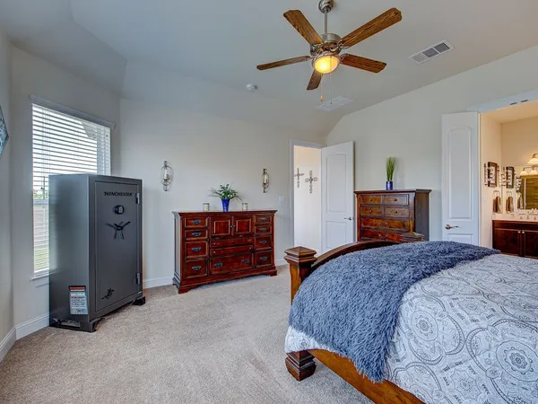 a bedroom with a bed and a chandelier