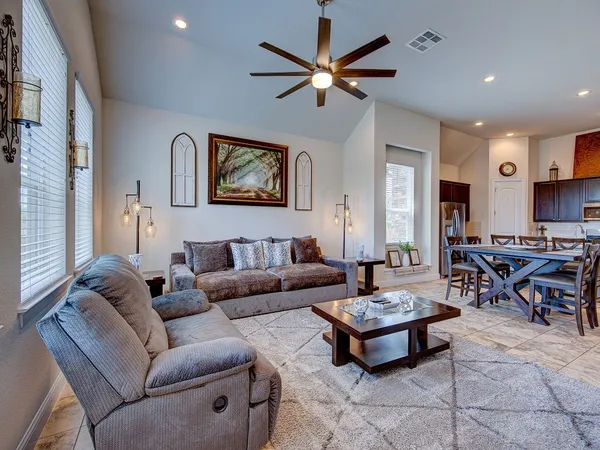 a living room with furniture a rug and a window