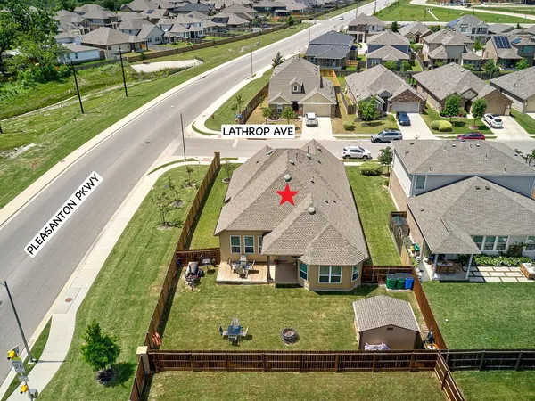 an aerial view of residential houses with outdoor space and swimming pool
