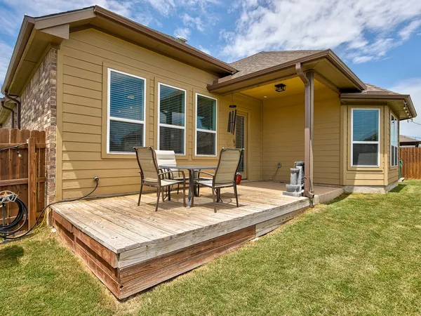 a front view of a house with outdoor seating and barbeque oven
