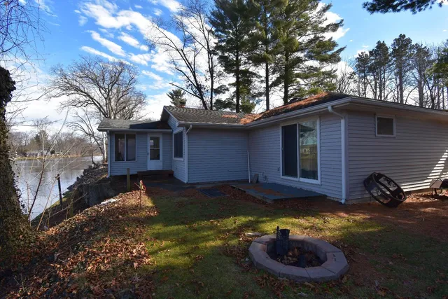 a view of a house with backyard wooden floor and a tree
