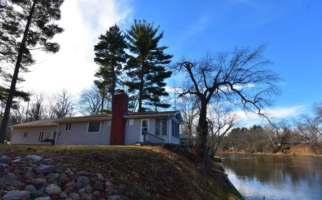 a tree in front of a house with a tree