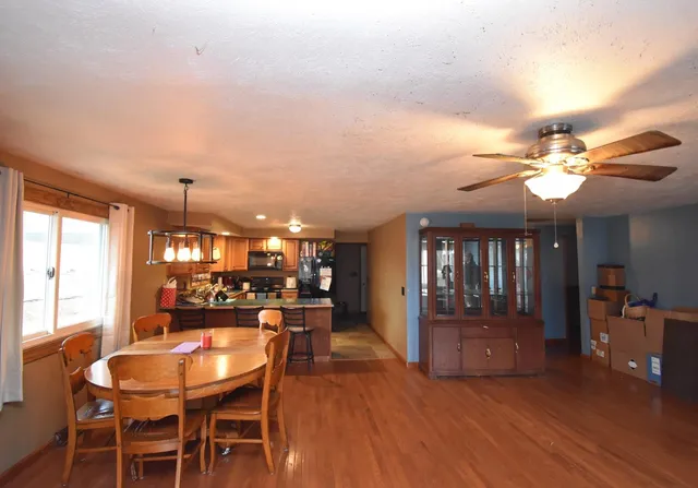 a view of a dining room with furniture and chandelier