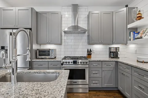 a stove top oven sitting inside of a kitchen