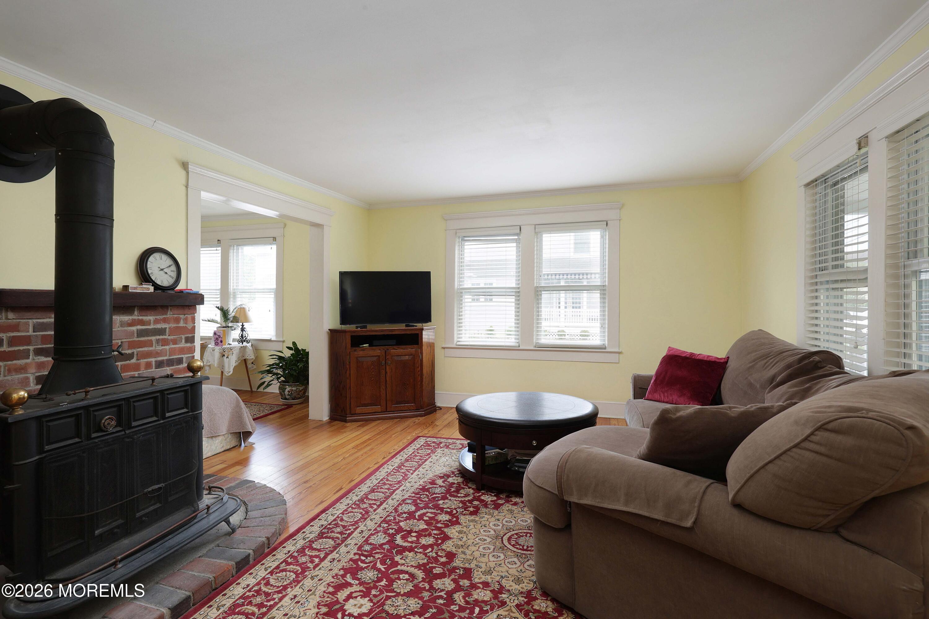 715 Howe Street Point Pleasant, NJ 08742 - Photo 6 of 45 a living room with furniture a flat screen tv and a fireplace