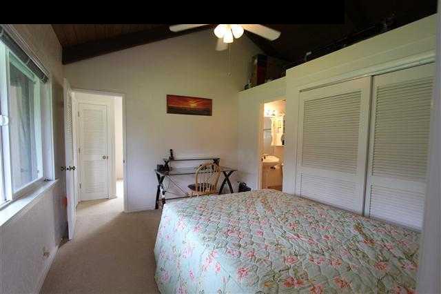 215 Maia Road Hana, HI 96713 - Photo 16 of 23 a bedroom with a bed and a chandelier