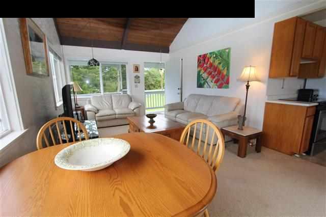 215 Maia Road Hana, HI 96713 - Photo 8 of 23 a dining room with furniture a flat screen tv and a large window