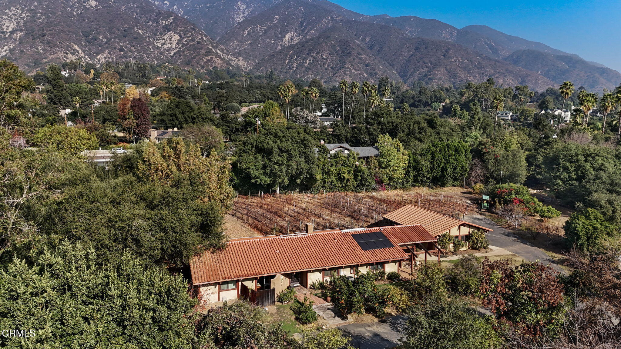an aerial view of house with backyard space and mountain view
