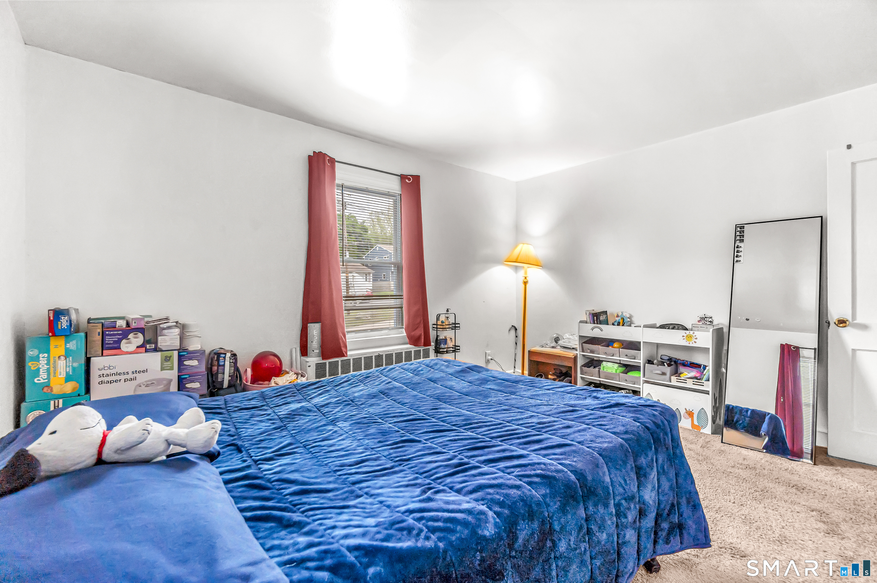 214 Thames Street New London, CT 06320 - Photo 19 of 33 a bed sitting in a bedroom next to a window