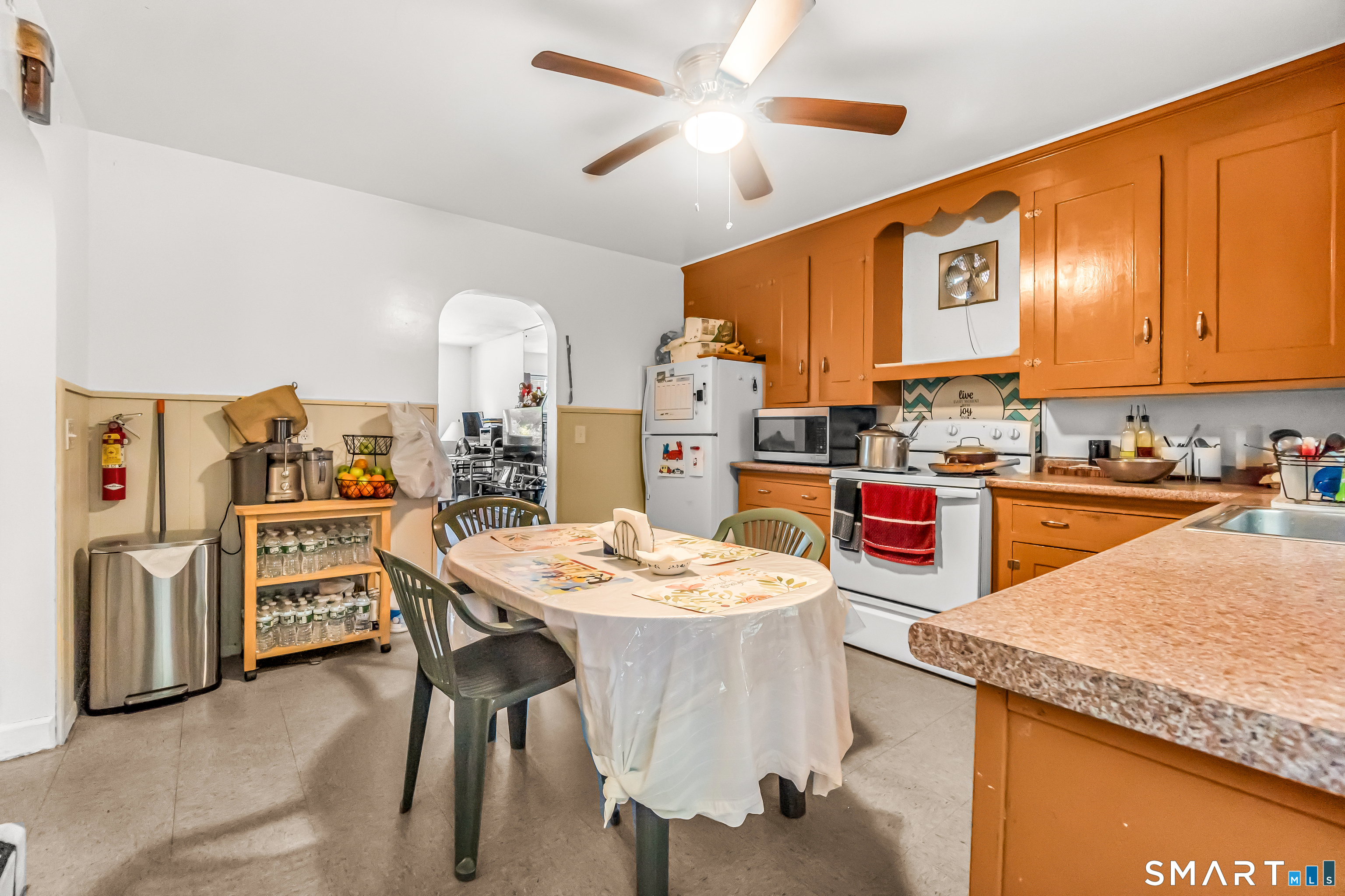 214 Thames Street New London, CT 06320 - Photo 10 of 33 a open kitchen with stainless steel appliances kitchen island granite countertop a table chairs and a refrigerator
