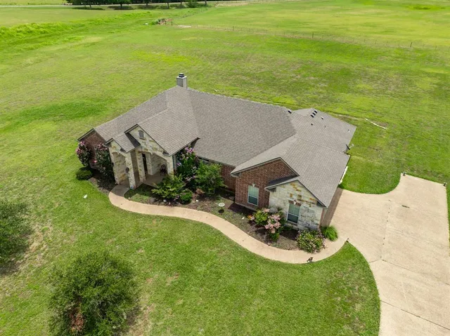 an aerial view of a house with a garden