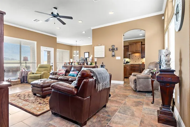 a living room with furniture potted plant and a chandelier