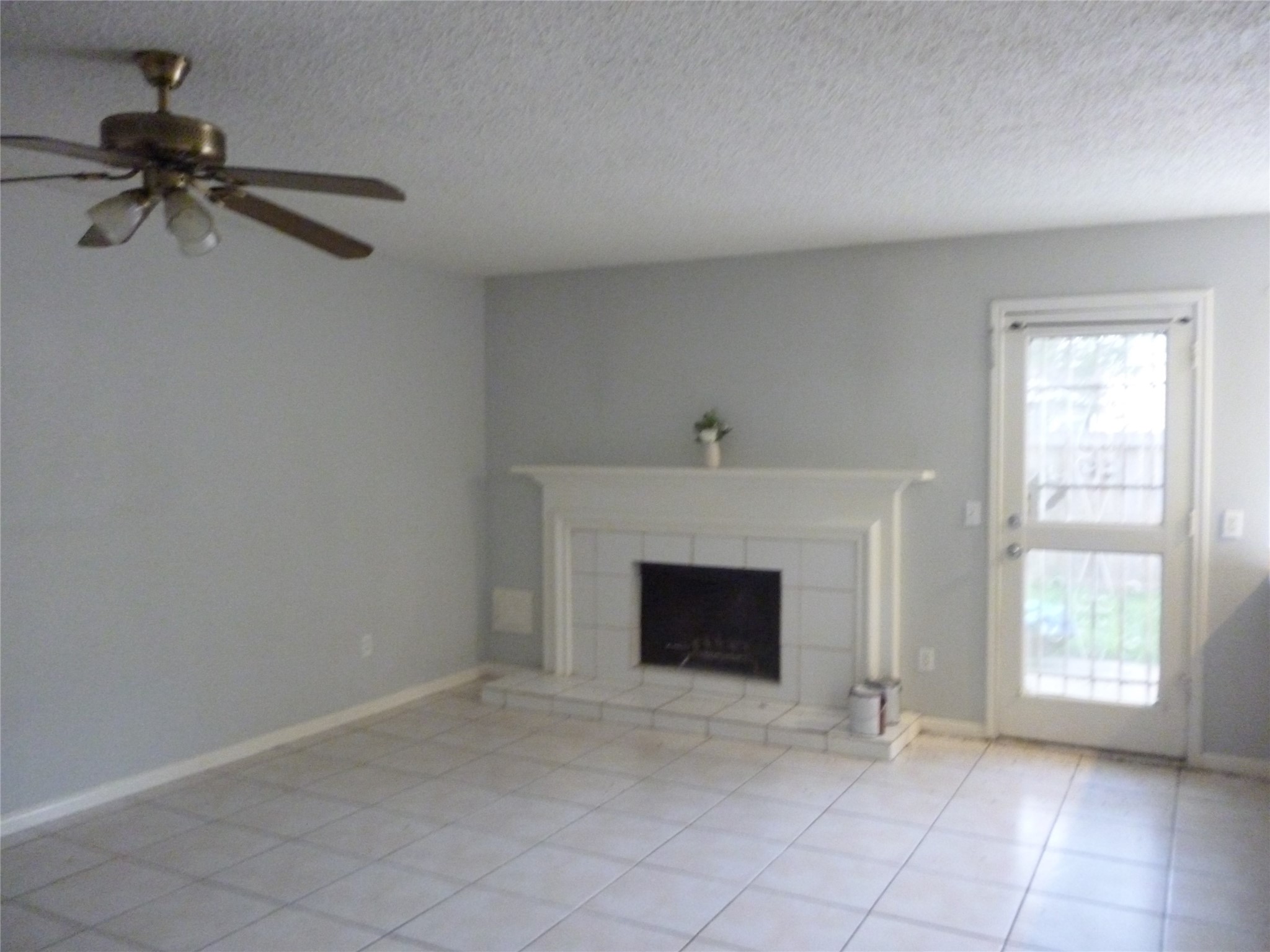 3243 Battle Ridge Lane Sugar Land, TX 77479 - Photo 7 of 34 a view of an empty room with a fireplace and a window
