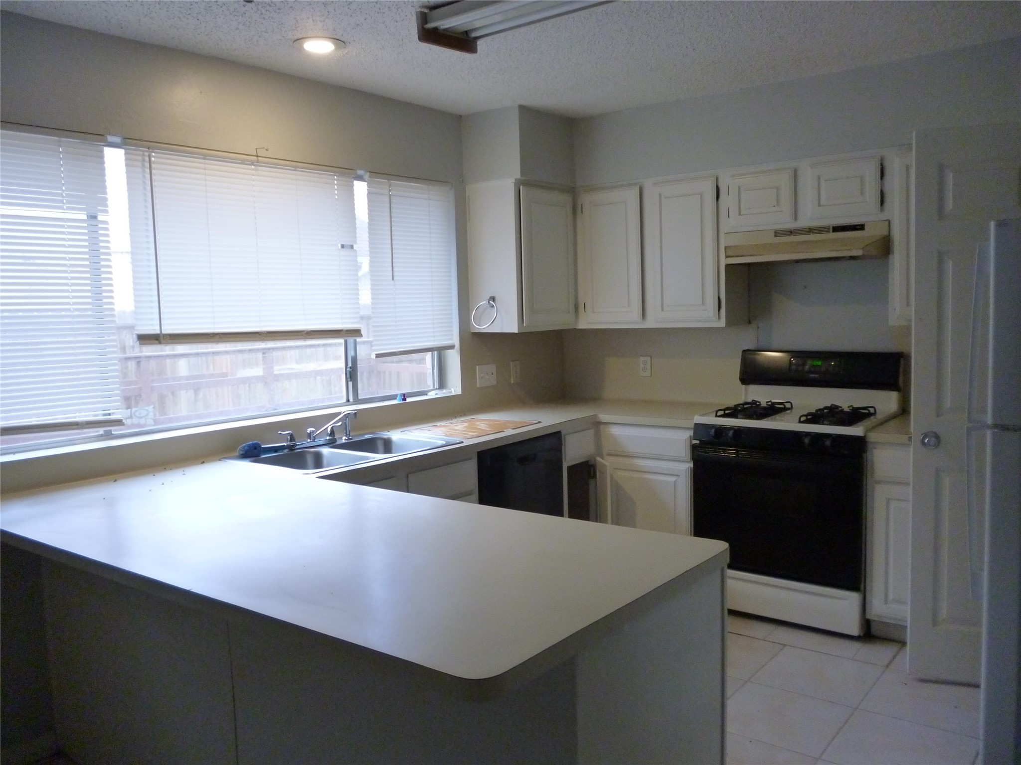 3243 Battle Ridge Lane Sugar Land, TX 77479 - Photo 9 of 34 a kitchen with a sink a stove and cabinets