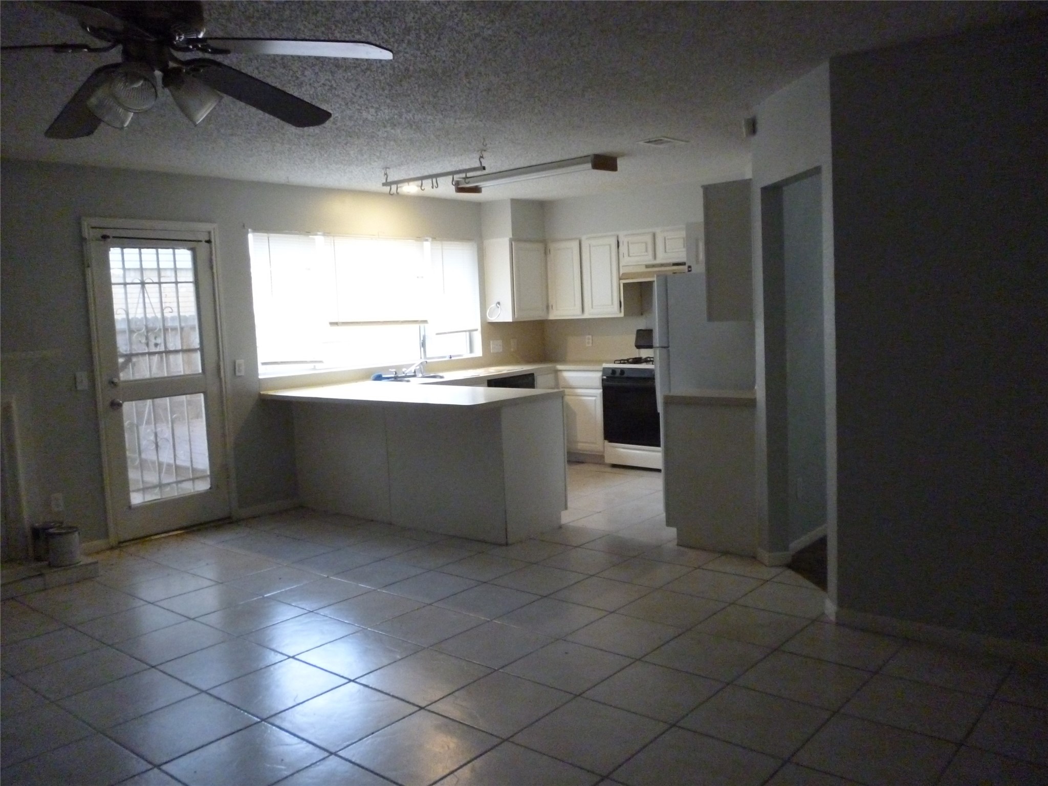 3243 Battle Ridge Lane Sugar Land, TX 77479 - Photo 10 of 34 a kitchen with stainless steel appliances kitchen island granite countertop a refrigerator and a sink