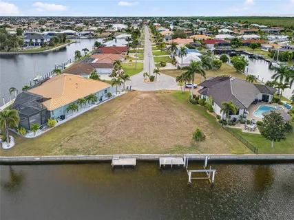 an aerial view of residential houses with outdoor space and lake view