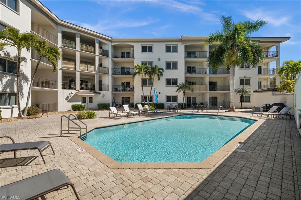 1100 Pine Ridge Road, Unit B103 Naples, FL 34108 - Photo 35 of 38 a view of a house with swimming pool and sitting area