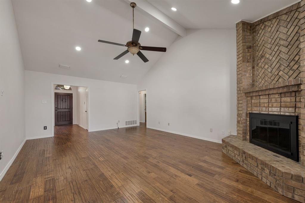 3305 Timber View Circle Bedford, TX 76021 - Photo 14 of 26 a view of empty room with wooden floor and fireplace
