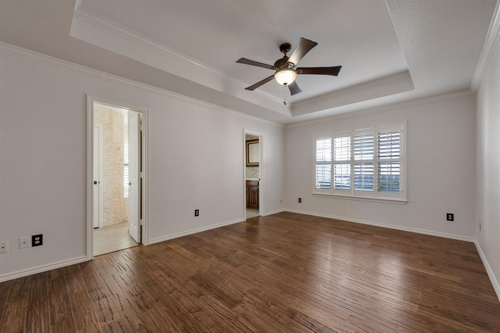 3305 Timber View Circle Bedford, TX 76021 - Photo 23 of 26 a view of empty room with wooden floor and fan