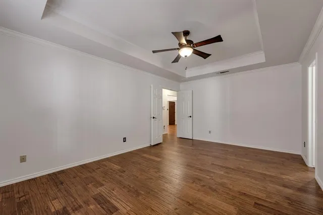 a view of an empty room with wooden floor