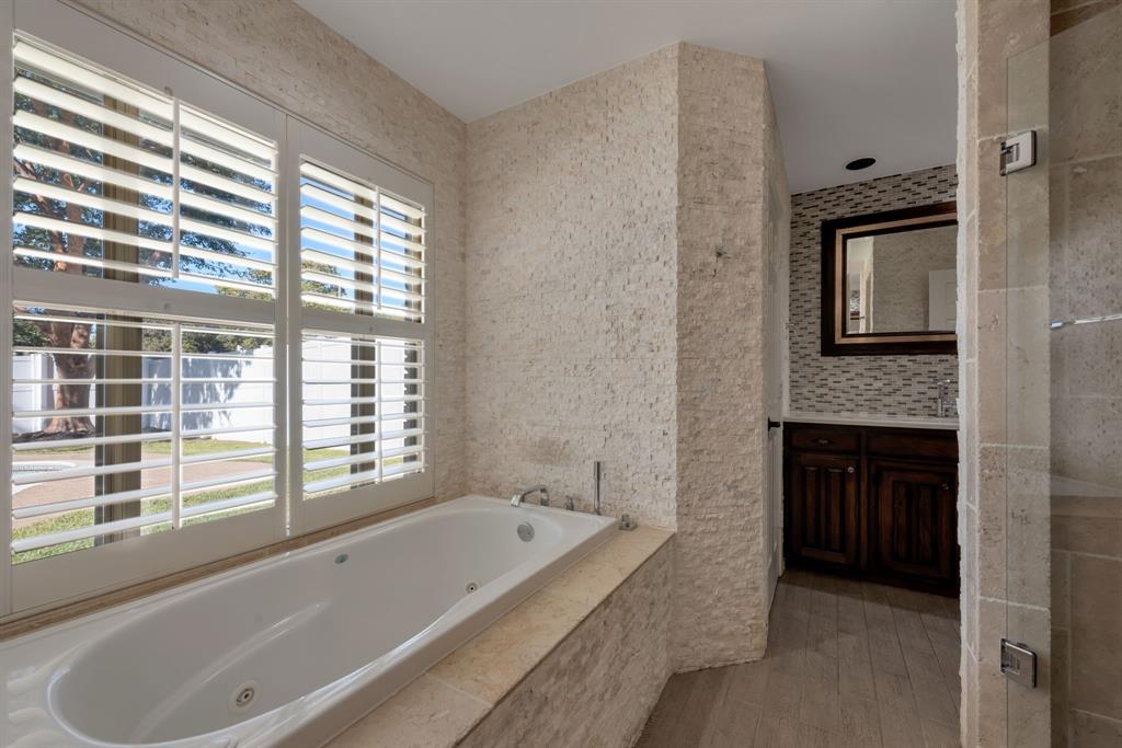 3305 Timber View Circle Bedford, TX 76021 - Photo 25 of 26 a bathroom with a tub a sink and a window