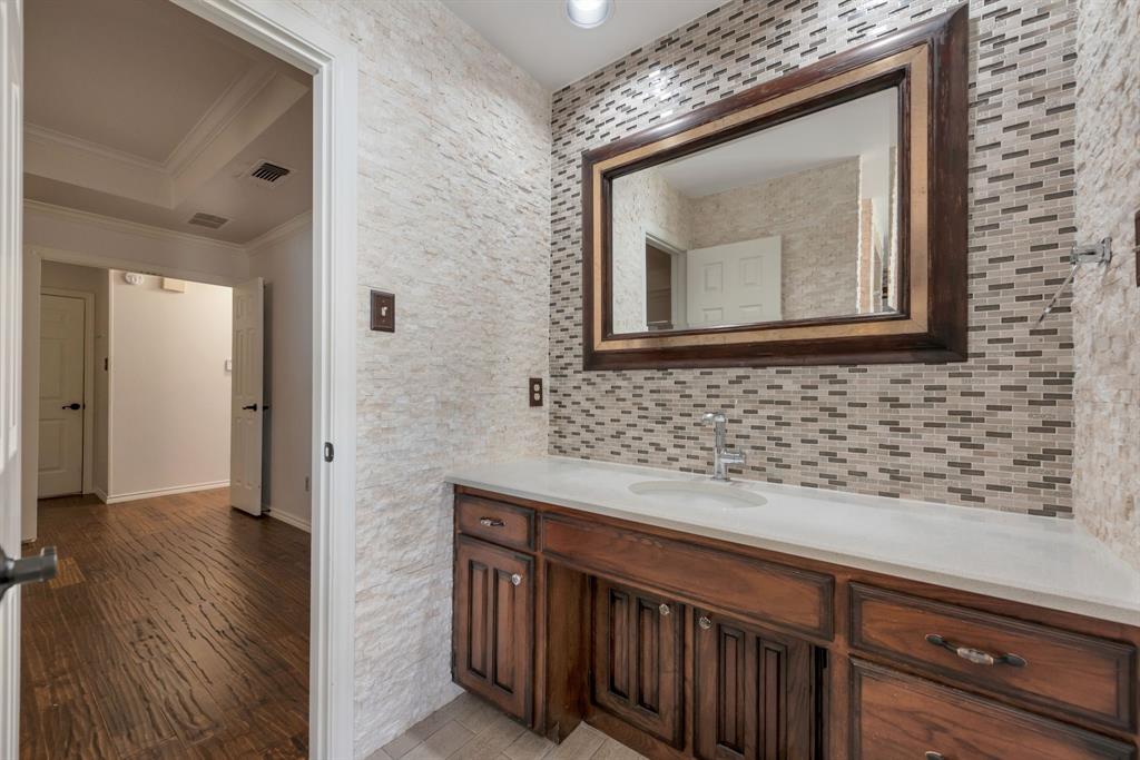 3305 Timber View Circle Bedford, TX 76021 - Photo 26 of 26 a bathroom with a sink a mirror and wooden floor