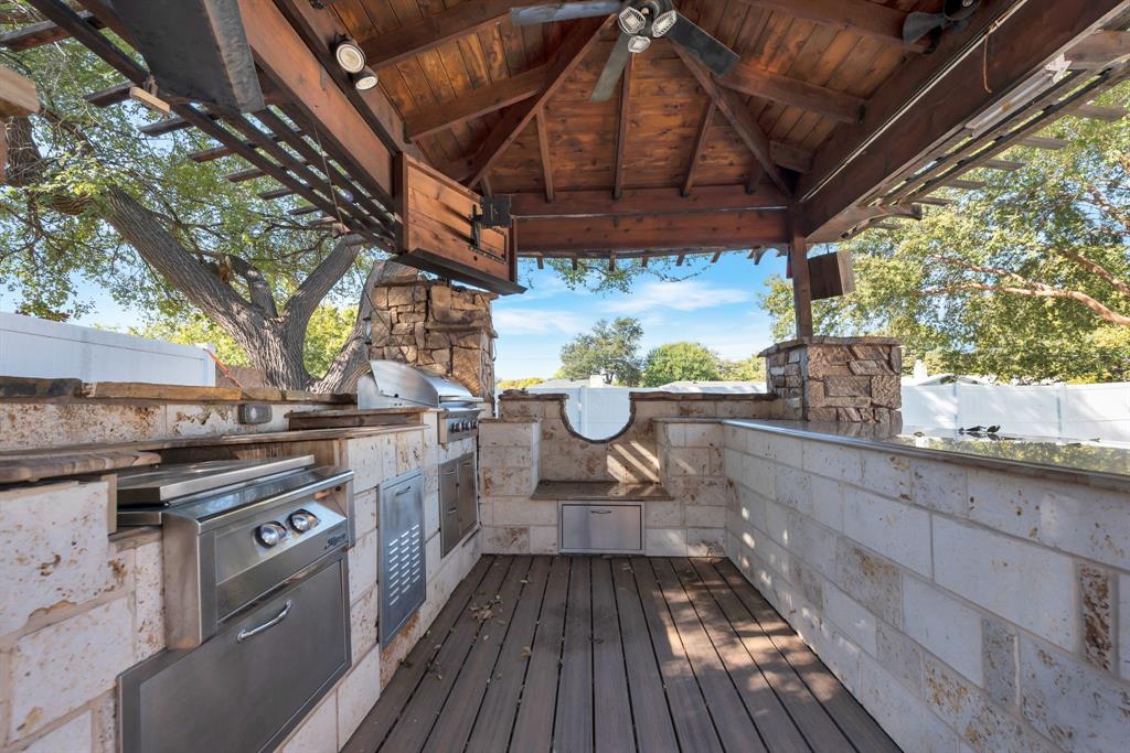 3305 Timber View Circle Bedford, TX 76021 - Photo 4 of 26 a kitchen with stainless steel appliances wooden floors and wooden cabinets