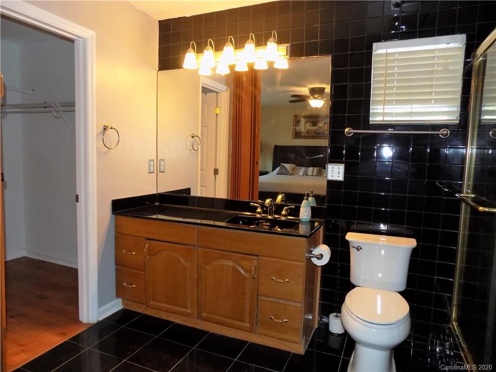 10117 Fairway Ridge Road Charlotte, NC 28277 - Photo 14 of 29 a bathroom with a toilet sink and mirror