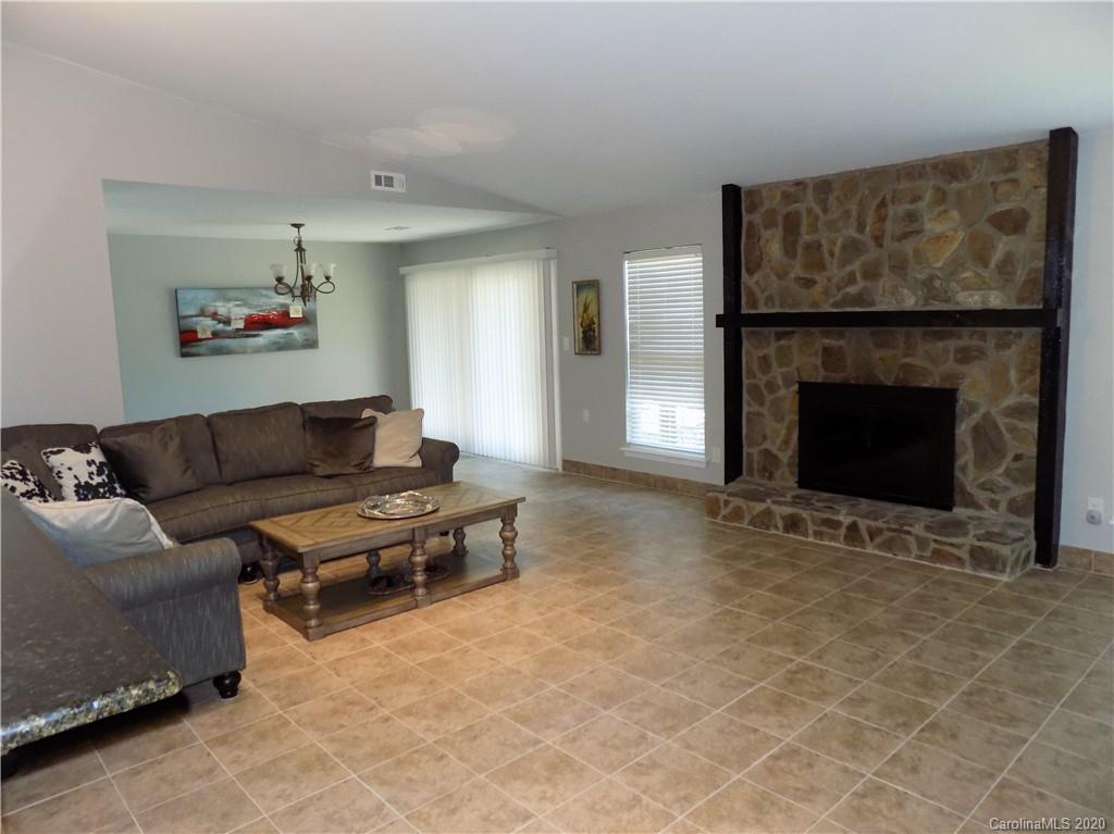 10117 Fairway Ridge Road Charlotte, NC 28277 - Photo 5 of 29 a living room with furniture and a fireplace