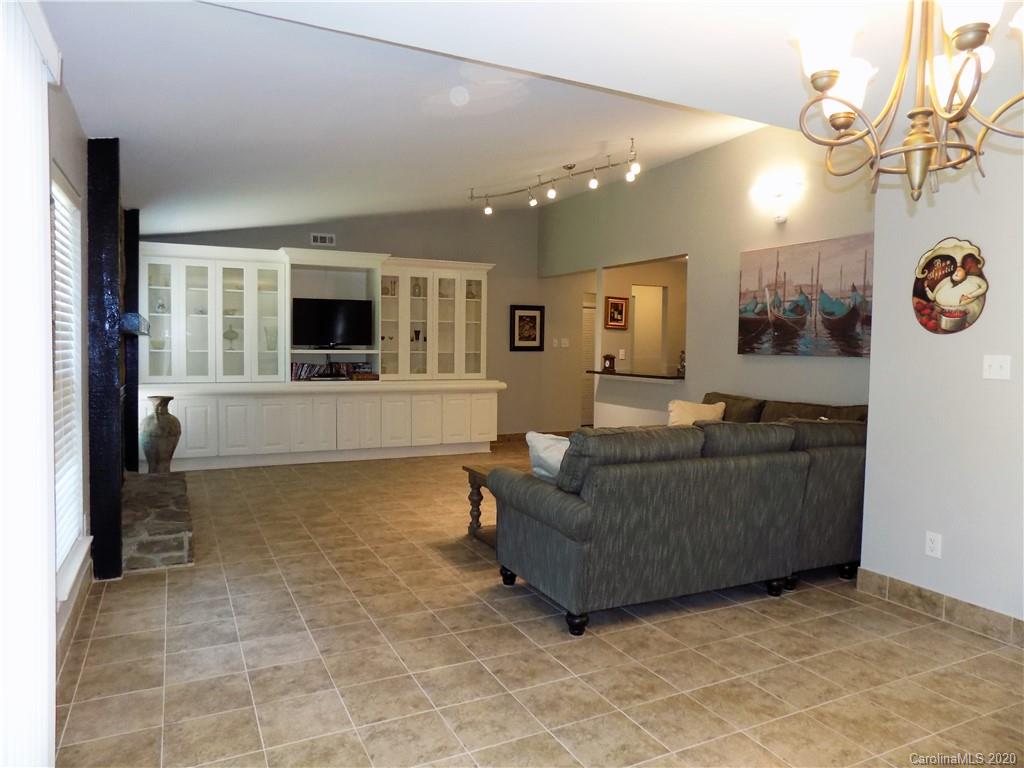 10117 Fairway Ridge Road Charlotte, NC 28277 - Photo 8 of 29 a living room with furniture and a flat screen tv