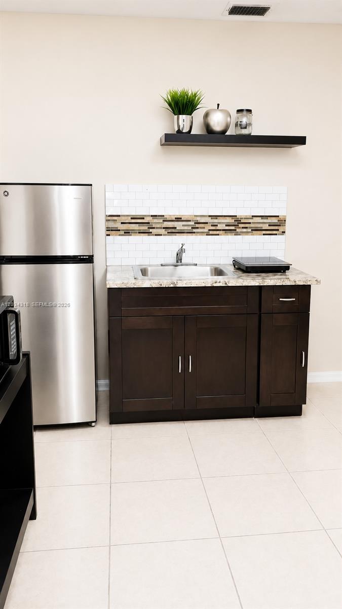 14856 Southwest 179th Street Miami, FL 33187 - Photo 12 of 33 a kitchen with a refrigerator and a cabinets