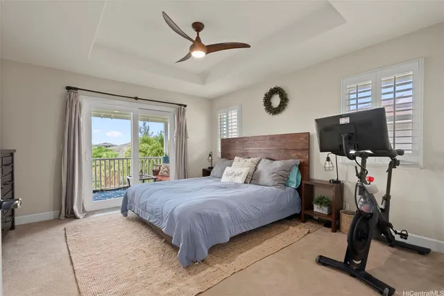 a bedroom with a bed tv and a window