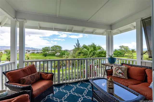 a balcony with wooden floor and outdoor seating