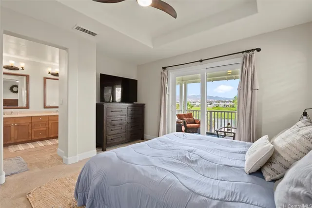 a bedroom with a large bed and a flat tv screen