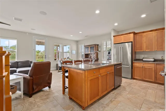 a kitchen with stainless steel appliances granite countertop a stove top oven a refrigerator a sink and dishwasher