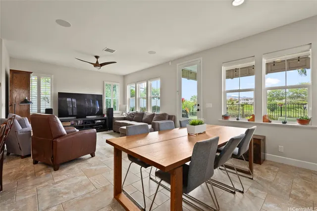 a living room with furniture a flat screen tv and a large window