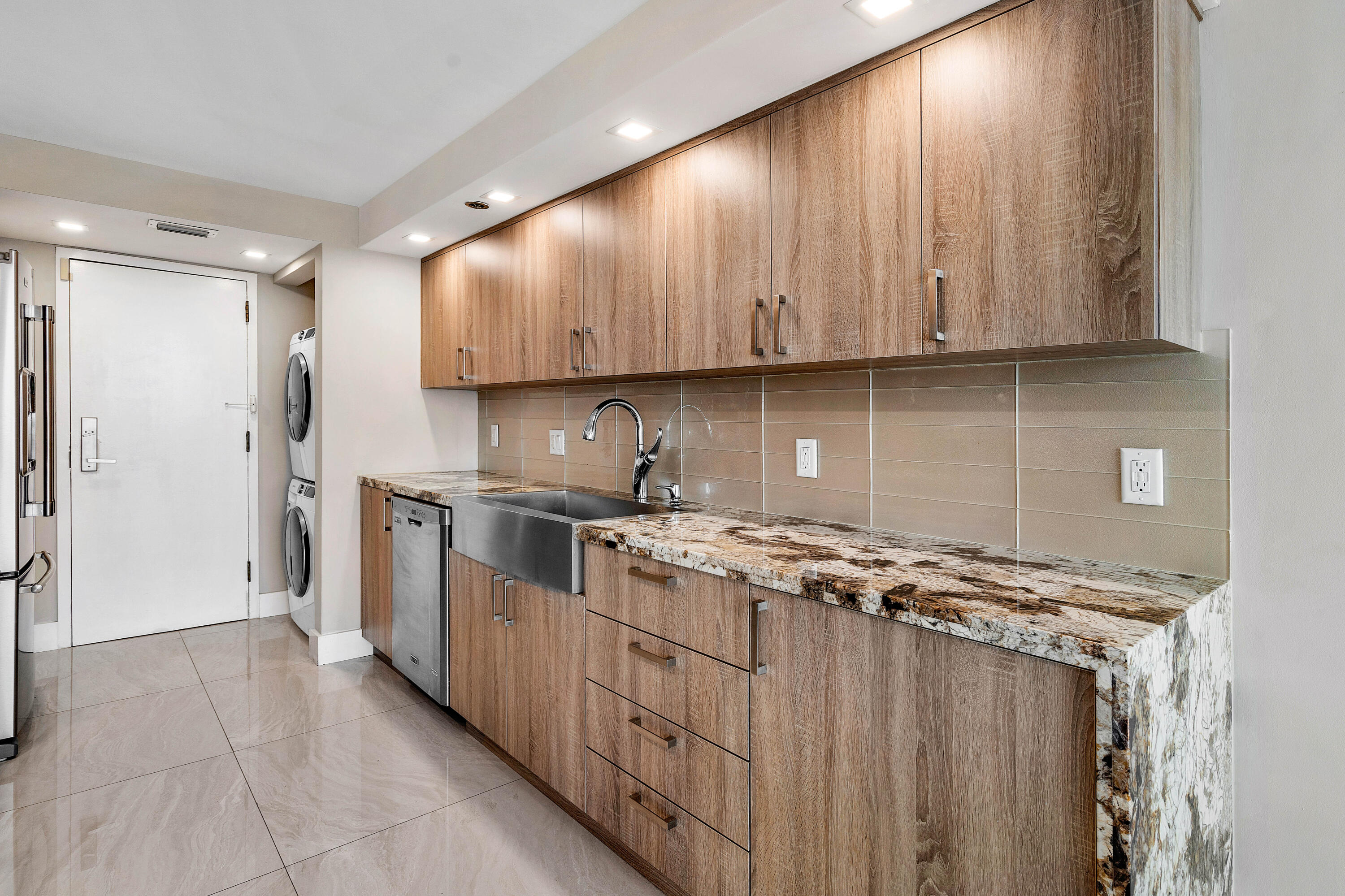 250 South Ocean Boulevard, Unit 7E Boca Raton, FL 33432 - Photo 17 of 45 a kitchen with stainless steel appliances granite countertop a stove a sink and a refrigerator