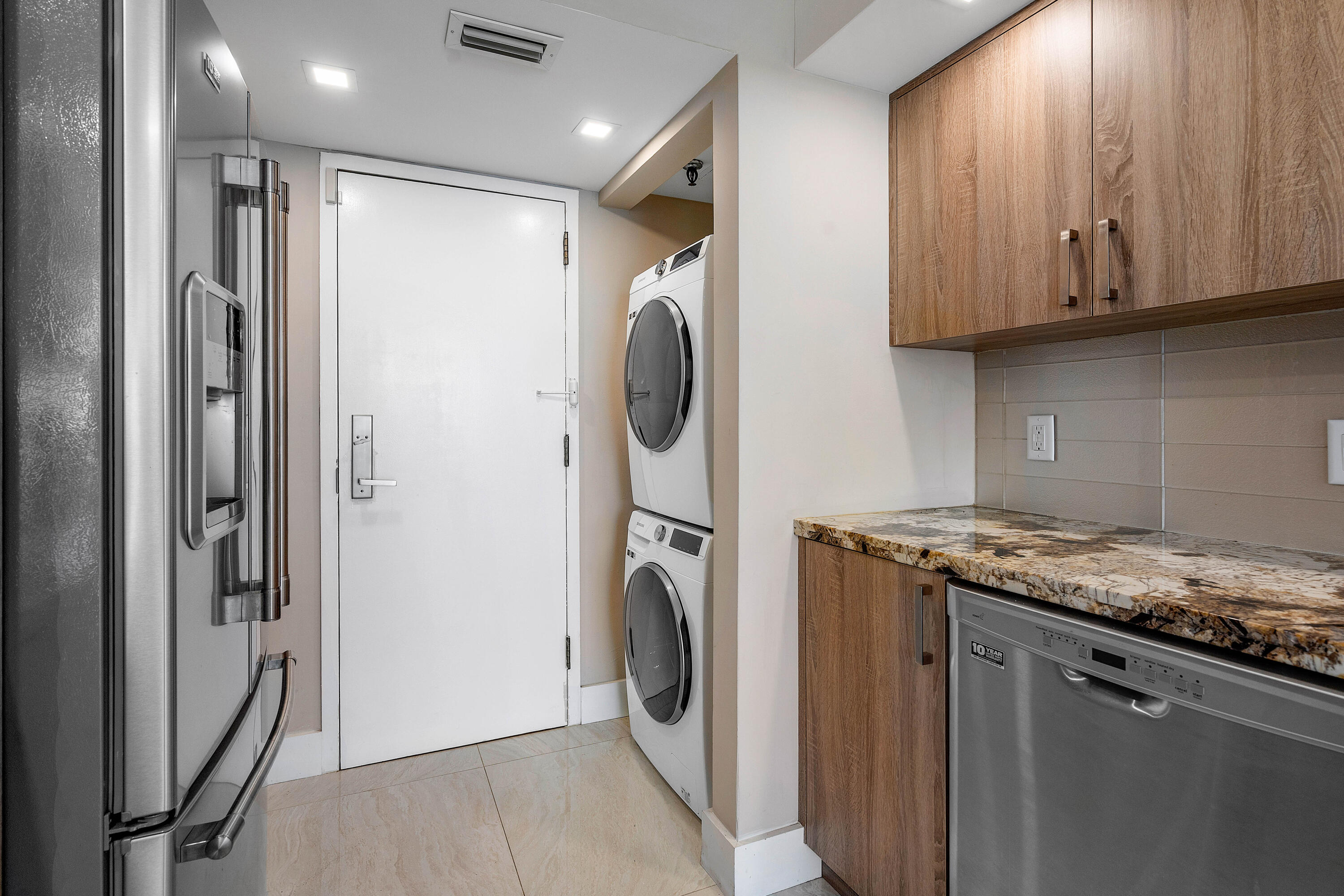250 South Ocean Boulevard, Unit 7E Boca Raton, FL 33432 - Photo 20 of 45 a utility room with wooden floor washer and dryer