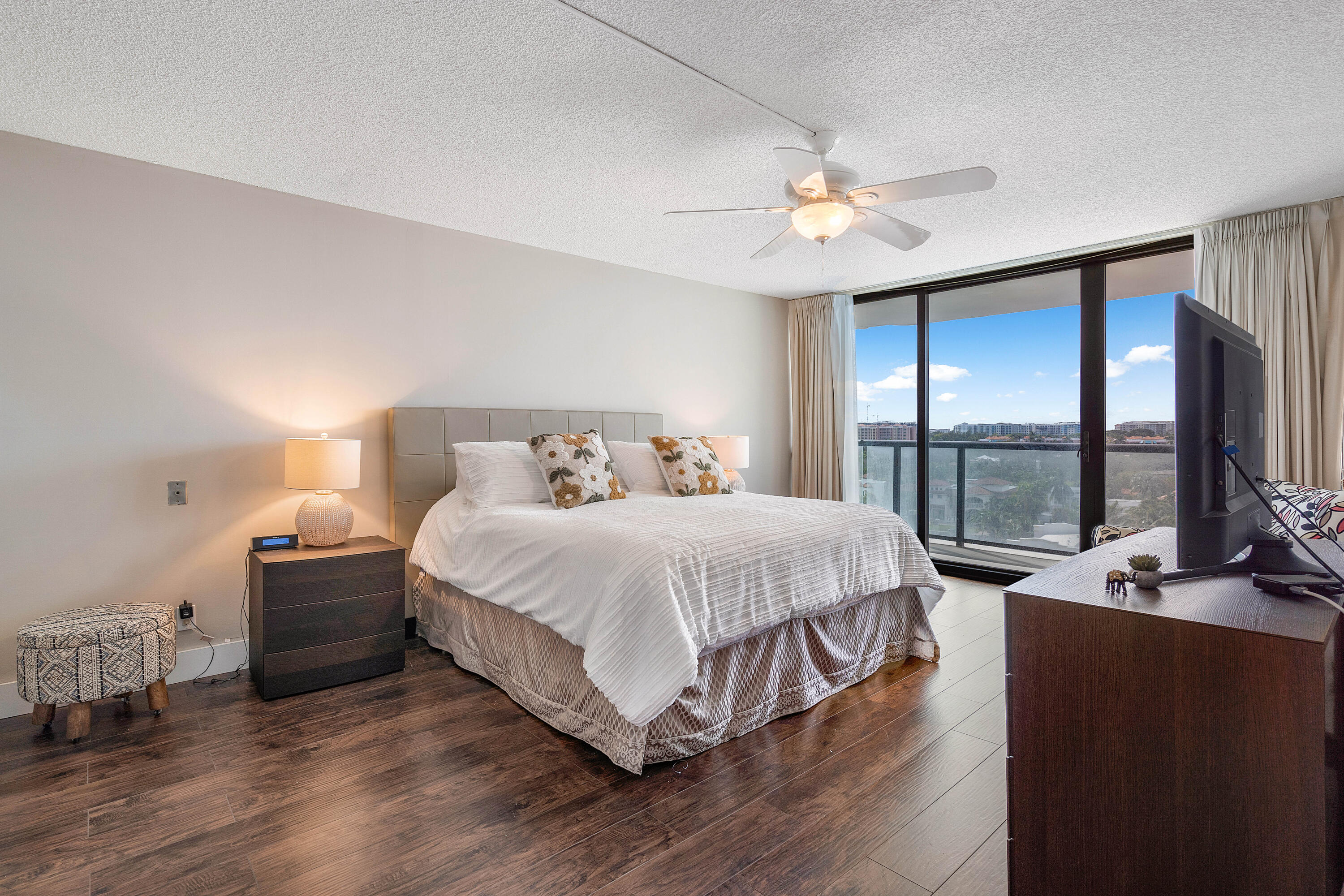 250 South Ocean Boulevard, Unit 7E Boca Raton, FL 33432 - Photo 22 of 45 a bedroom with a large bed and a chandelier