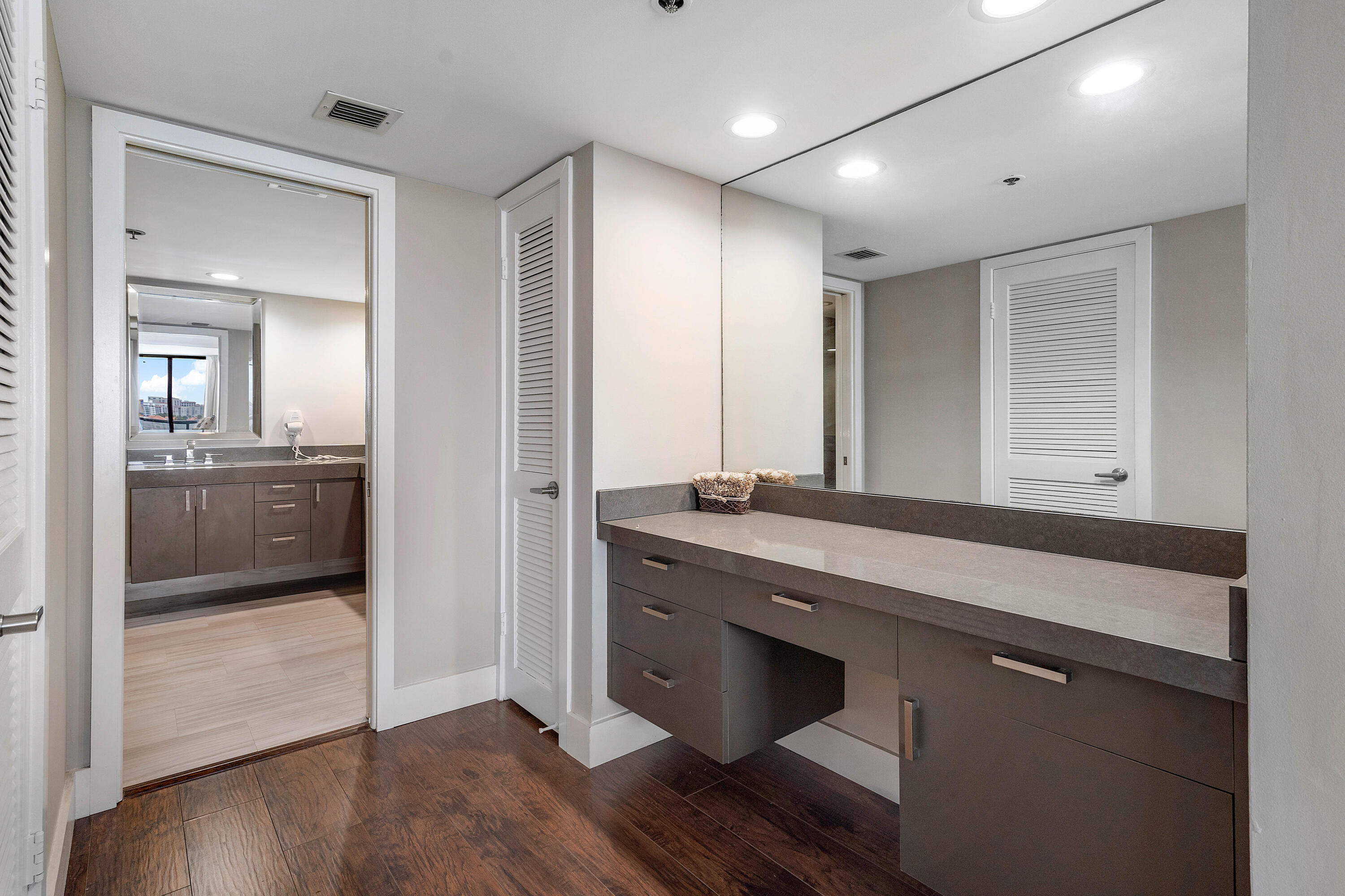 250 South Ocean Boulevard, Unit 7E Boca Raton, FL 33432 - Photo 25 of 45 a bathroom with a sink and a mirror