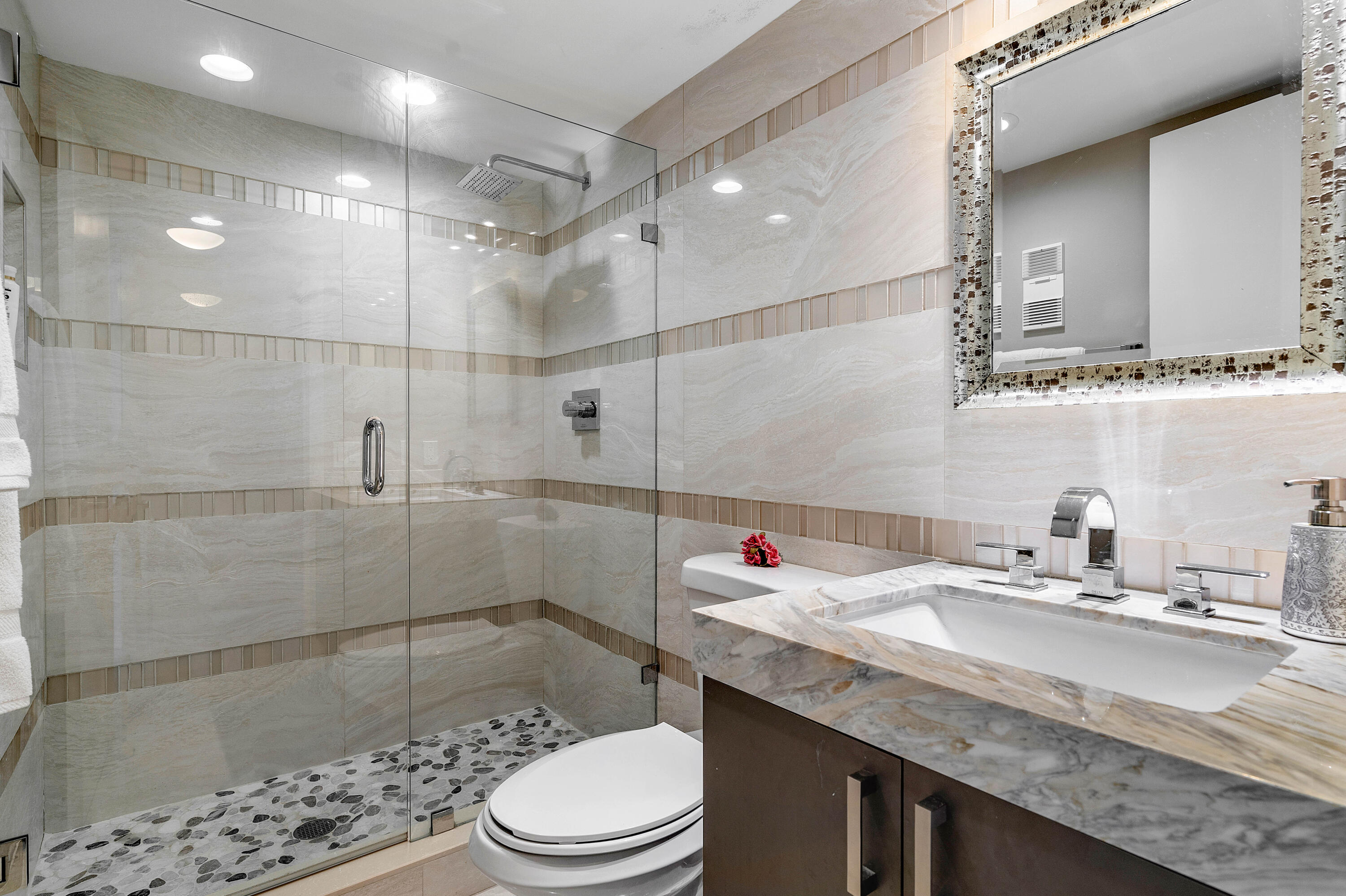 250 South Ocean Boulevard, Unit 7E Boca Raton, FL 33432 - Photo 29 of 45 a bathroom with a sink a toilet and shower