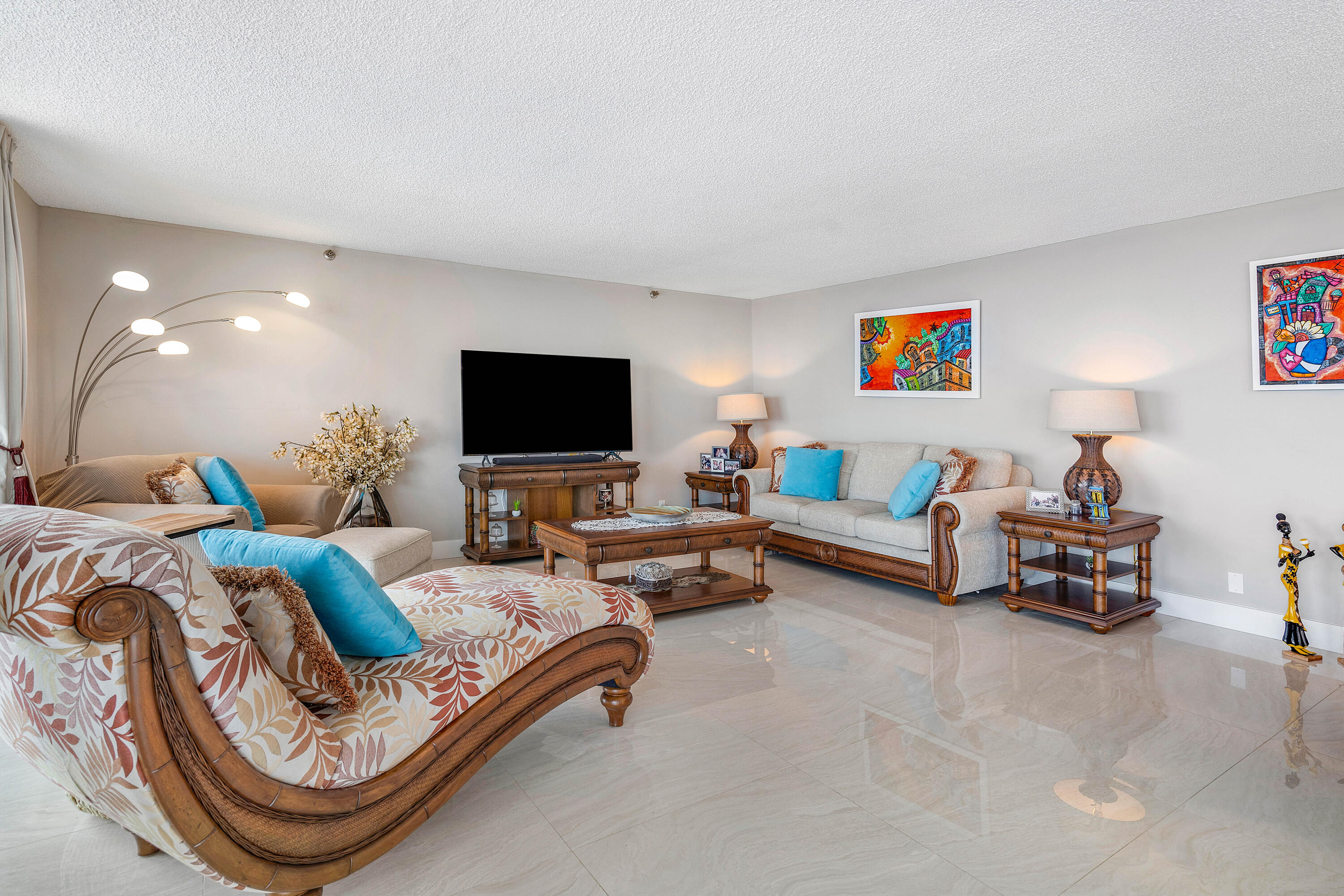 250 South Ocean Boulevard, Unit 7E Boca Raton, FL 33432 - Photo 9 of 45 a living room with furniture and a flat screen tv