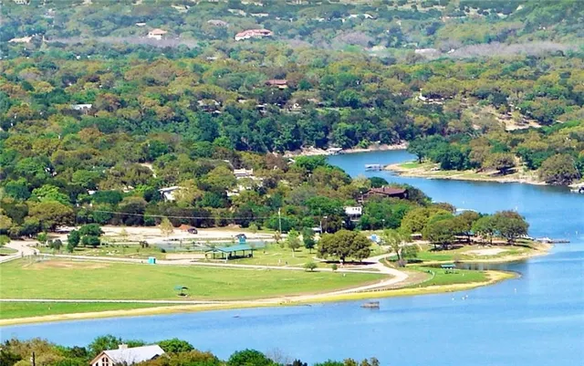 a view of a swimming pool with an ocean and trees