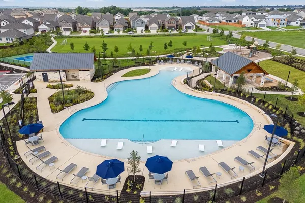 a view of yard with swimming pool and lawn chairs