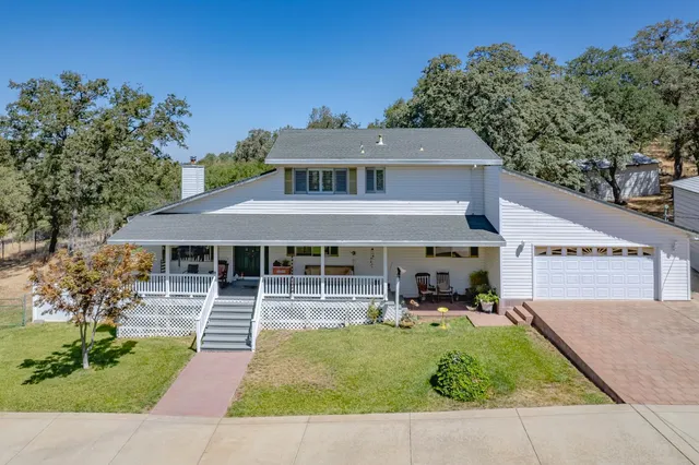 a view of balcony with chairs and wooden fence