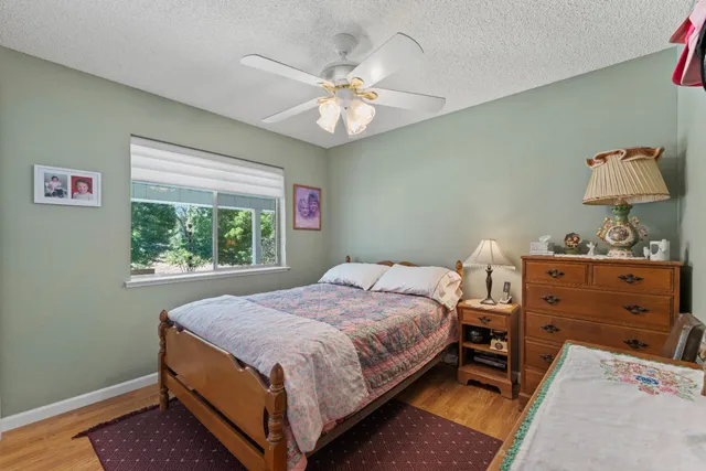 a bathroom with a sink a toilet a mirror and shower