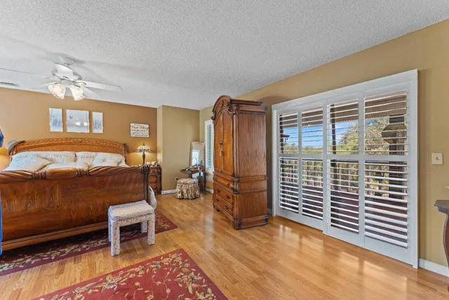 a view of a balcony with wooden floor and fence