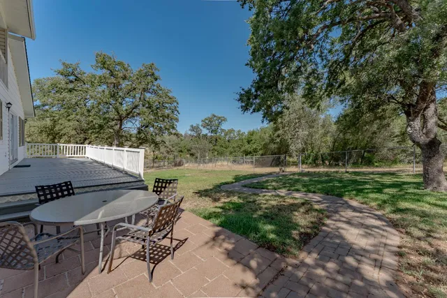 a front view of house with yard and trees in the background